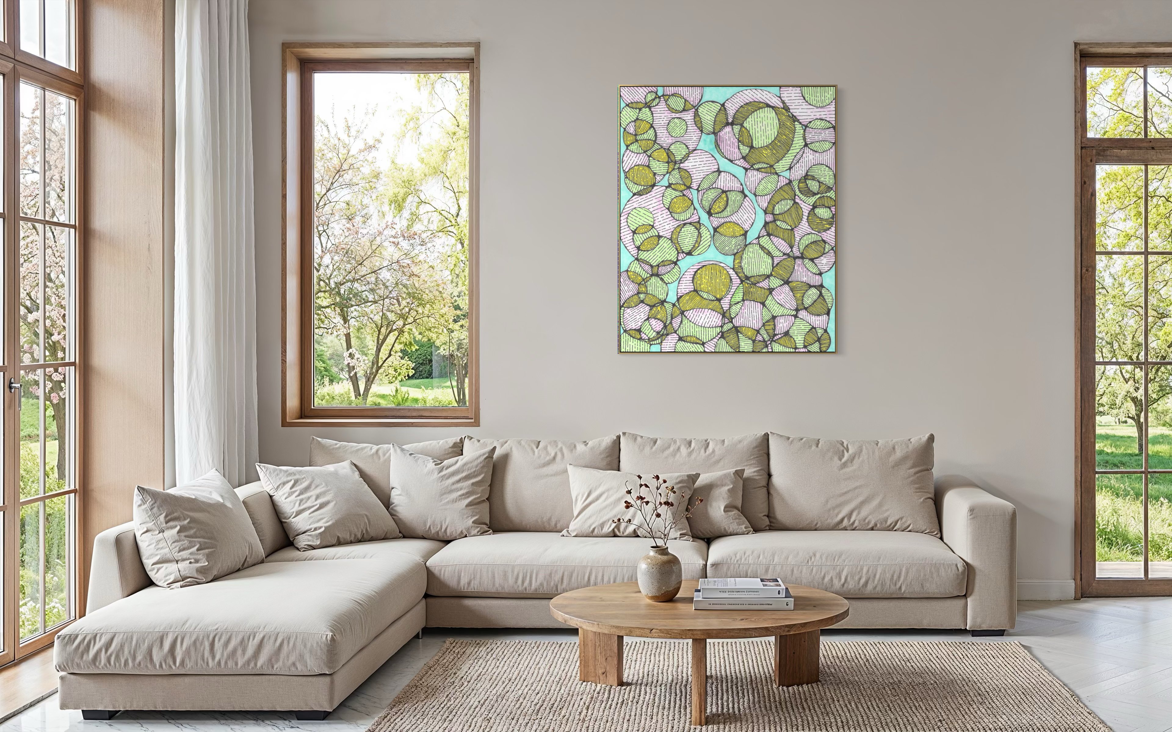 Charis artwork in a living room above a cream sectional sofa